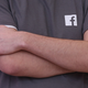 File photo of a Facebook employee wearing a t-shirt with a Facebook logo